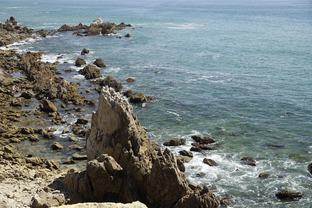 brown rock formation on sea during daytime