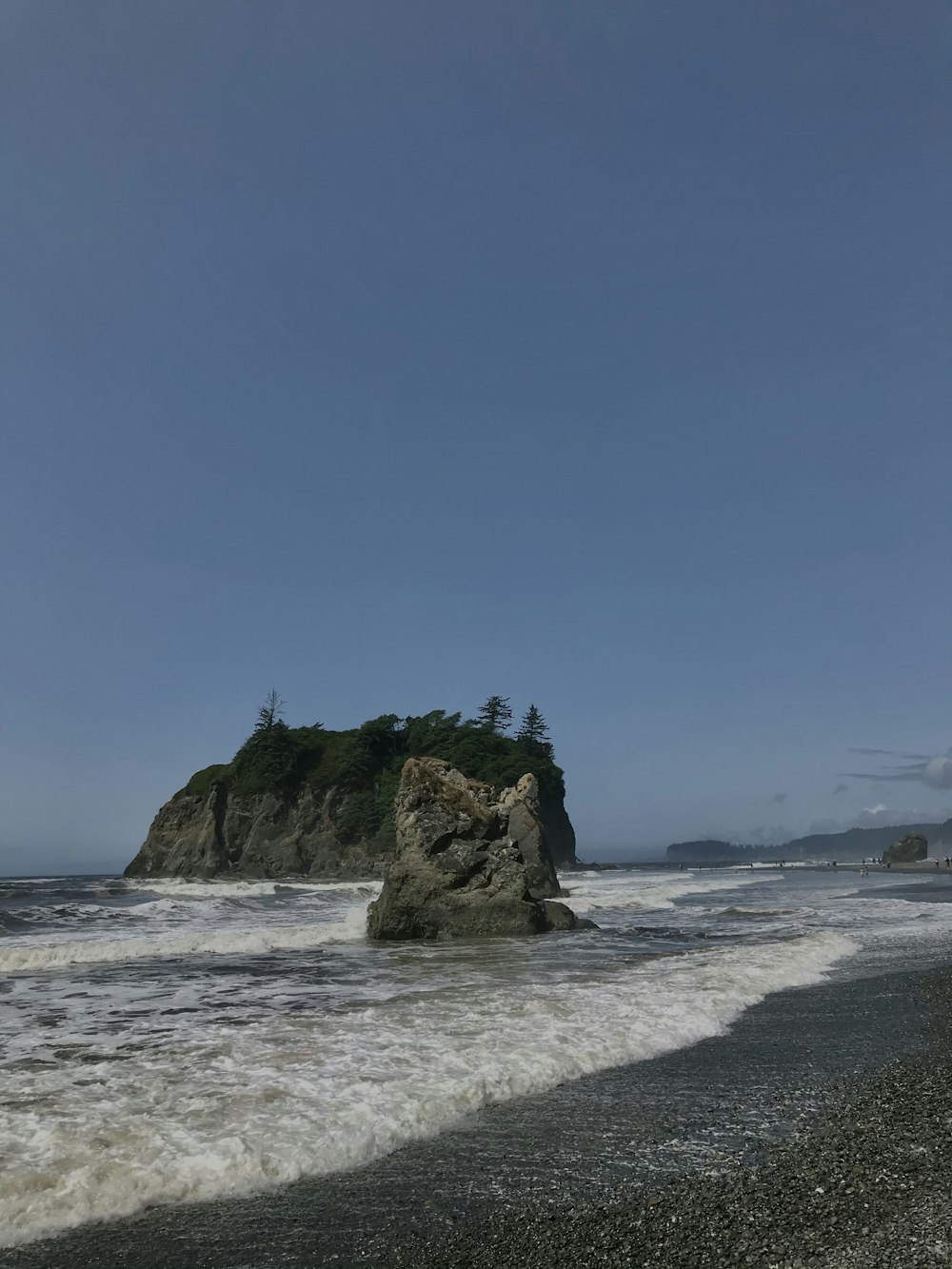 brown rock formation on beach during daytime