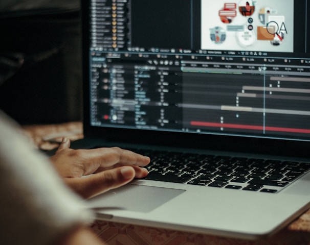 person using macbook pro on table