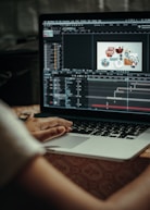 person using macbook pro on table