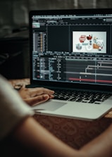 person using macbook pro on table