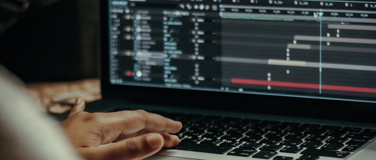 person using macbook pro on table