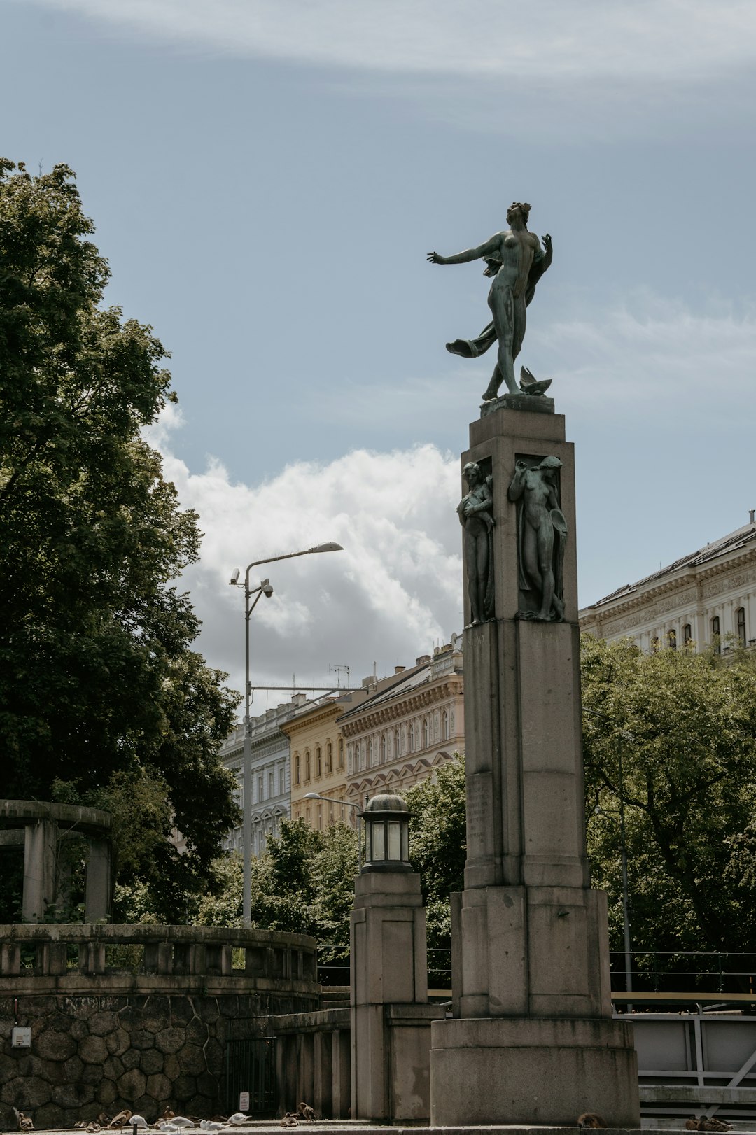 man riding horse statue near green trees during daytime