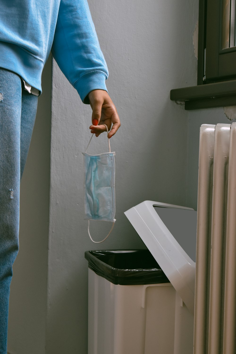 person in blue denim jeans holding clear plastic pack