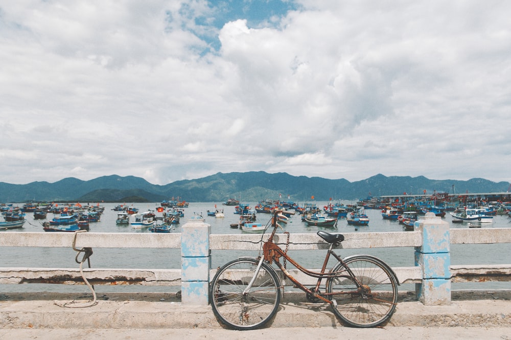 black and brown city bike on brown wooden dock during daytime