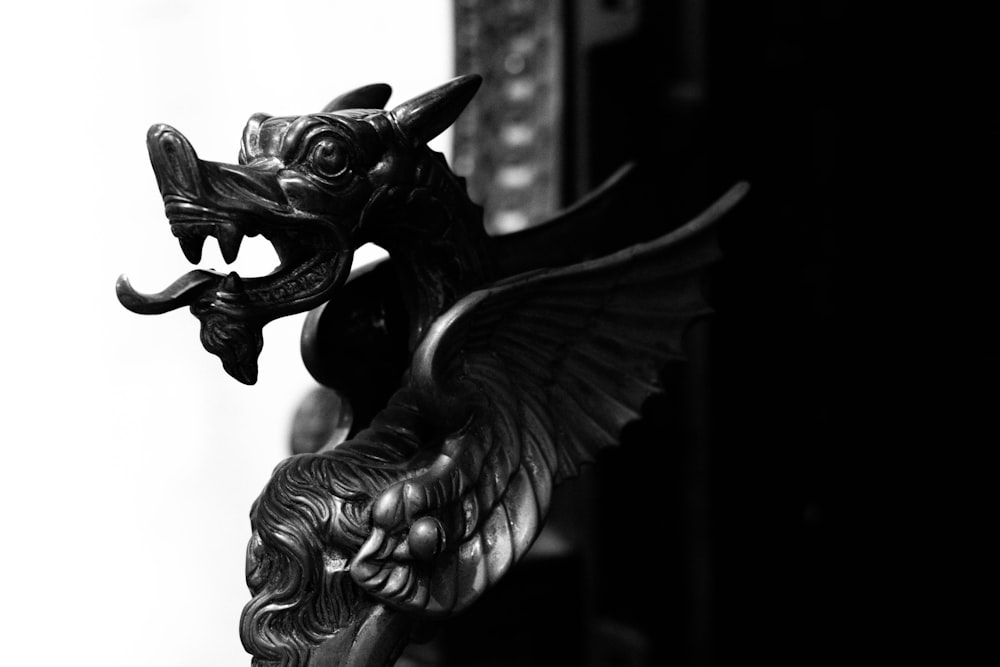 grayscale photo of dragon figurine