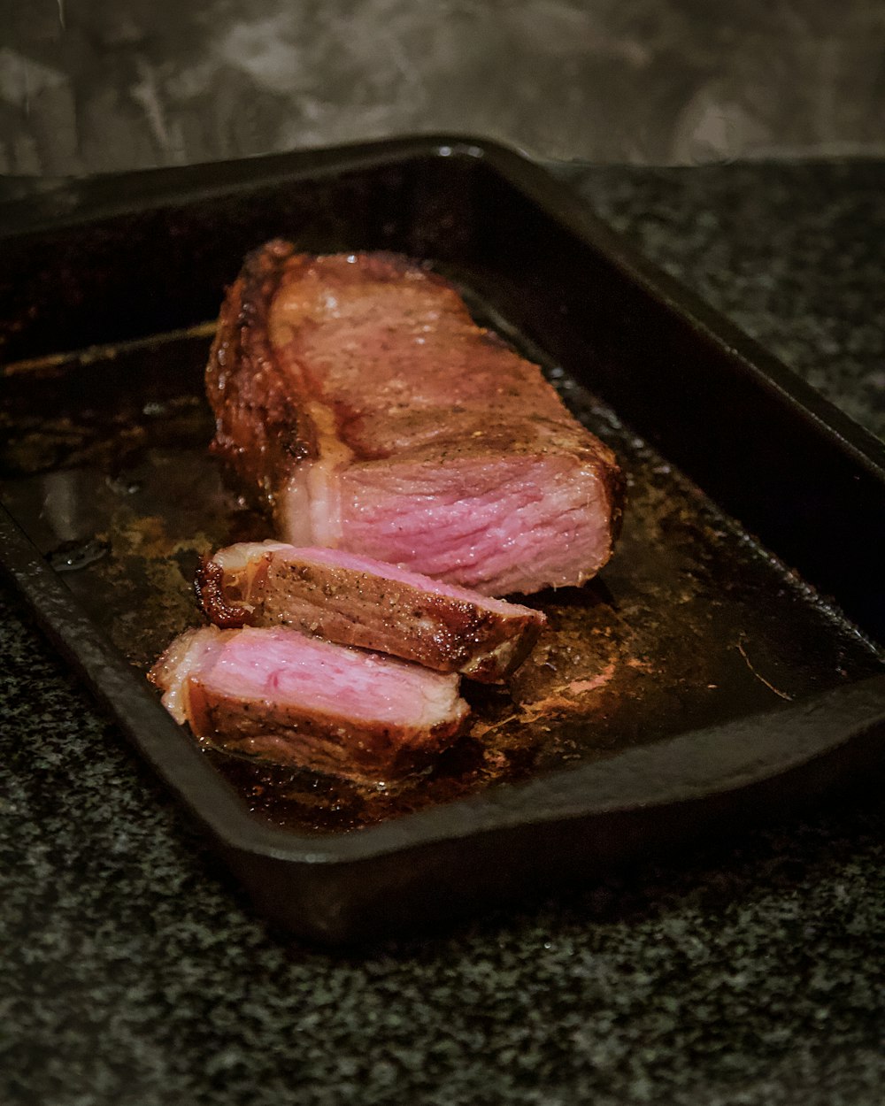 raw meat on black tray