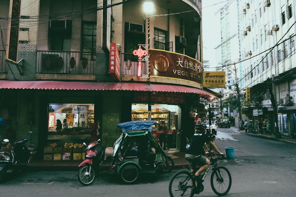 black motorcycle parked beside brown concrete building during daytime