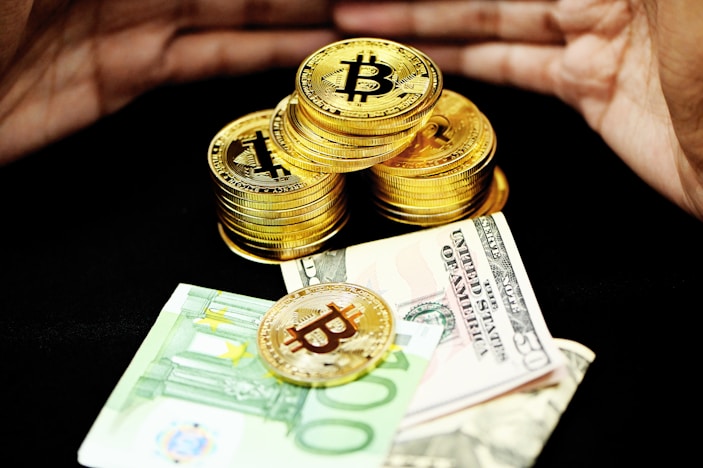 gold and silver coins on banknotes