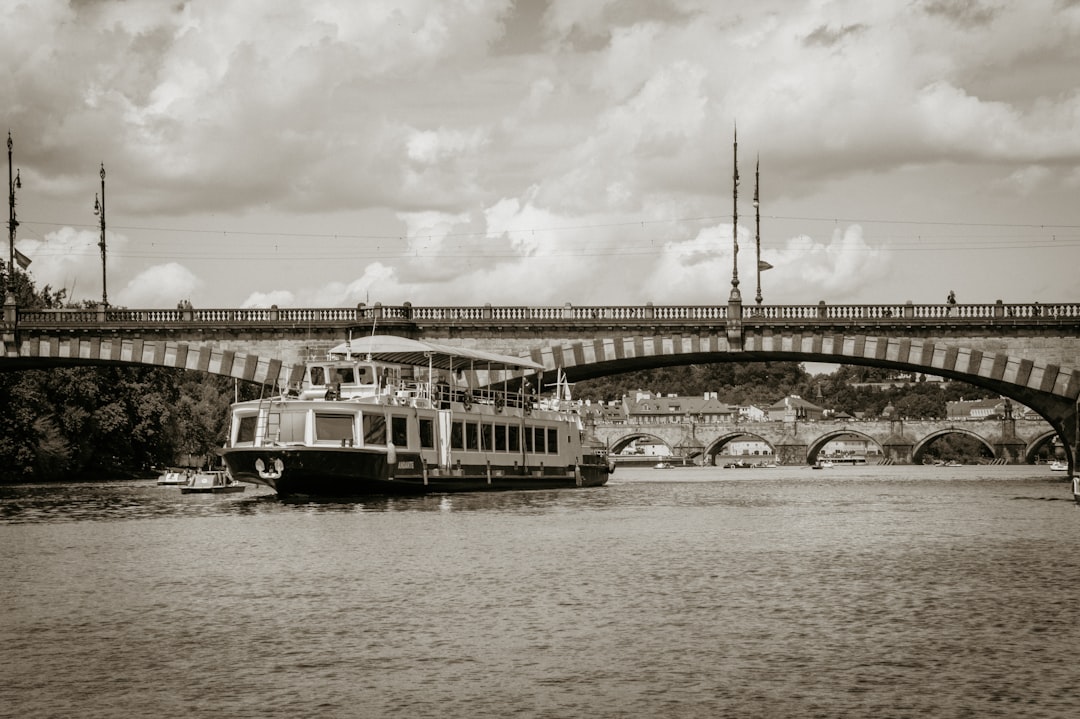 grayscale photo of white boat on body of water