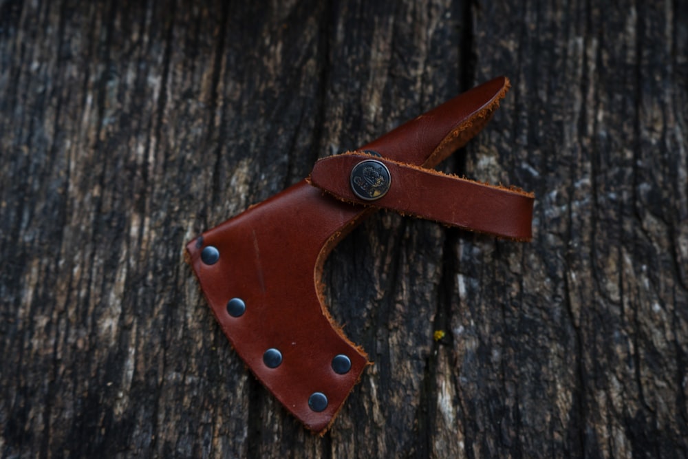 brown leather horse saddle on brown wooden surface