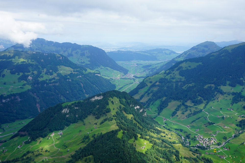 green mountains under white clouds during daytime