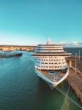 white and blue cruise ship on sea under blue sky during daytime
