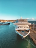 white and blue cruise ship on sea under blue sky during daytime