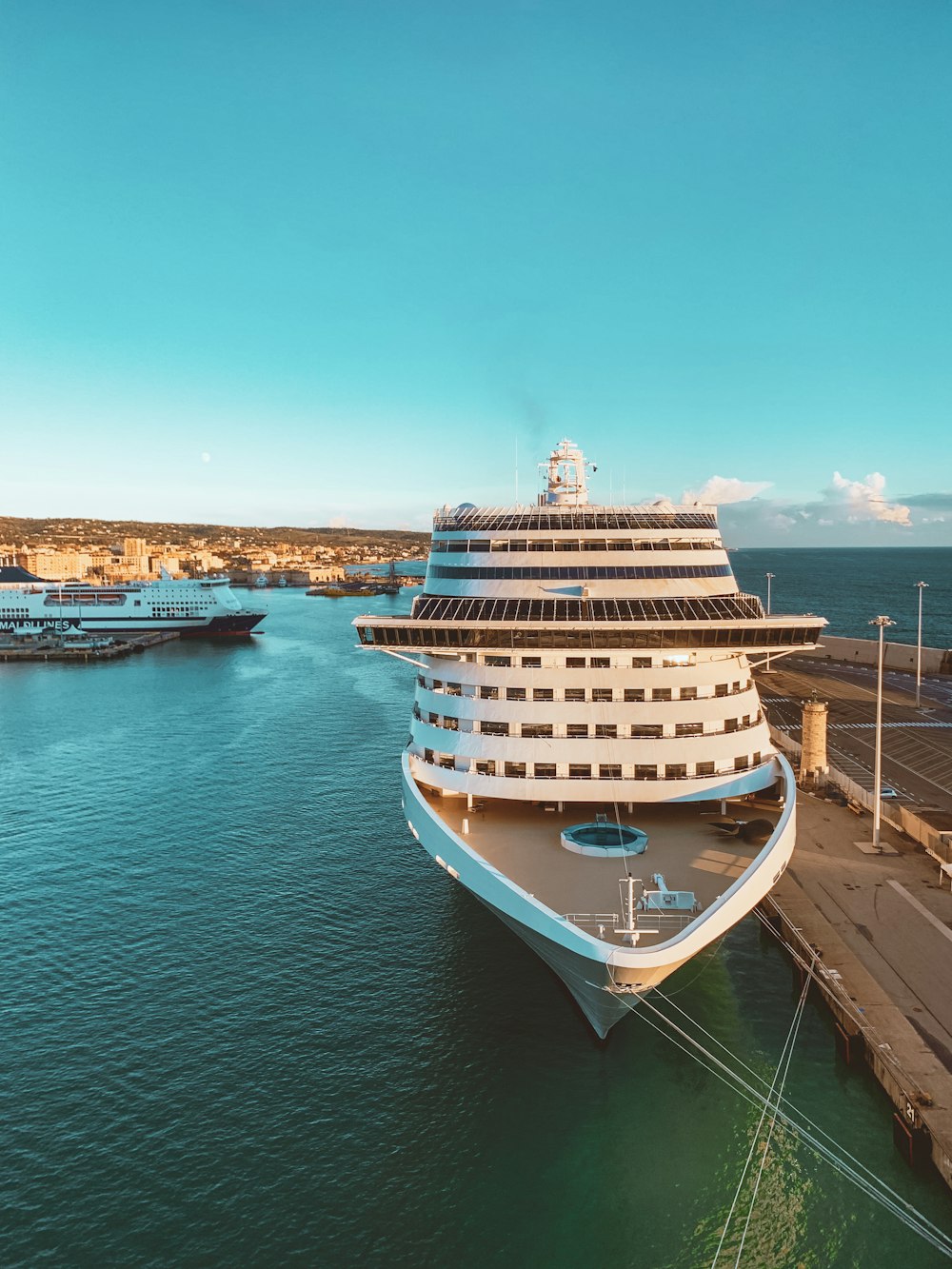 white and blue cruise ship on sea under blue sky during daytime