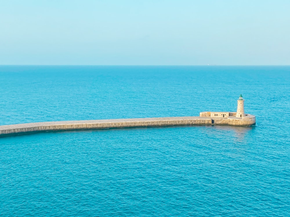 brown concrete dock on blue sea during daytime