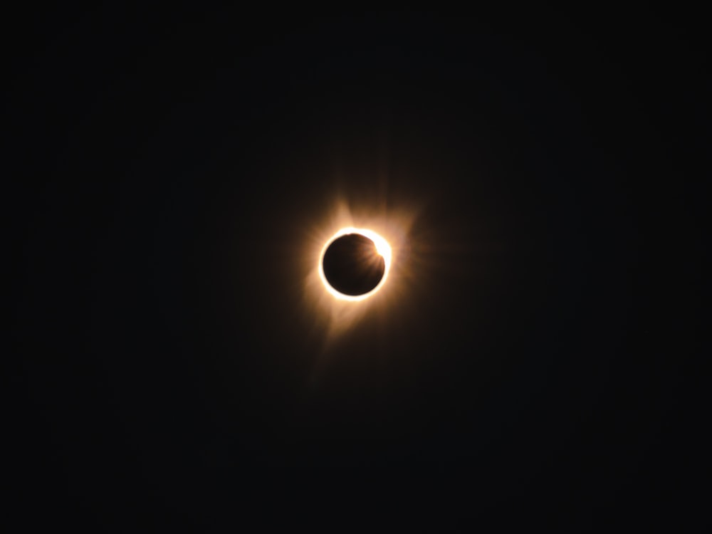 a solar eclipse is seen in the dark sky