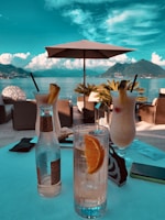 Guests enjoying tropical cocktails on the lively 5th Avenue terrace at sunset.