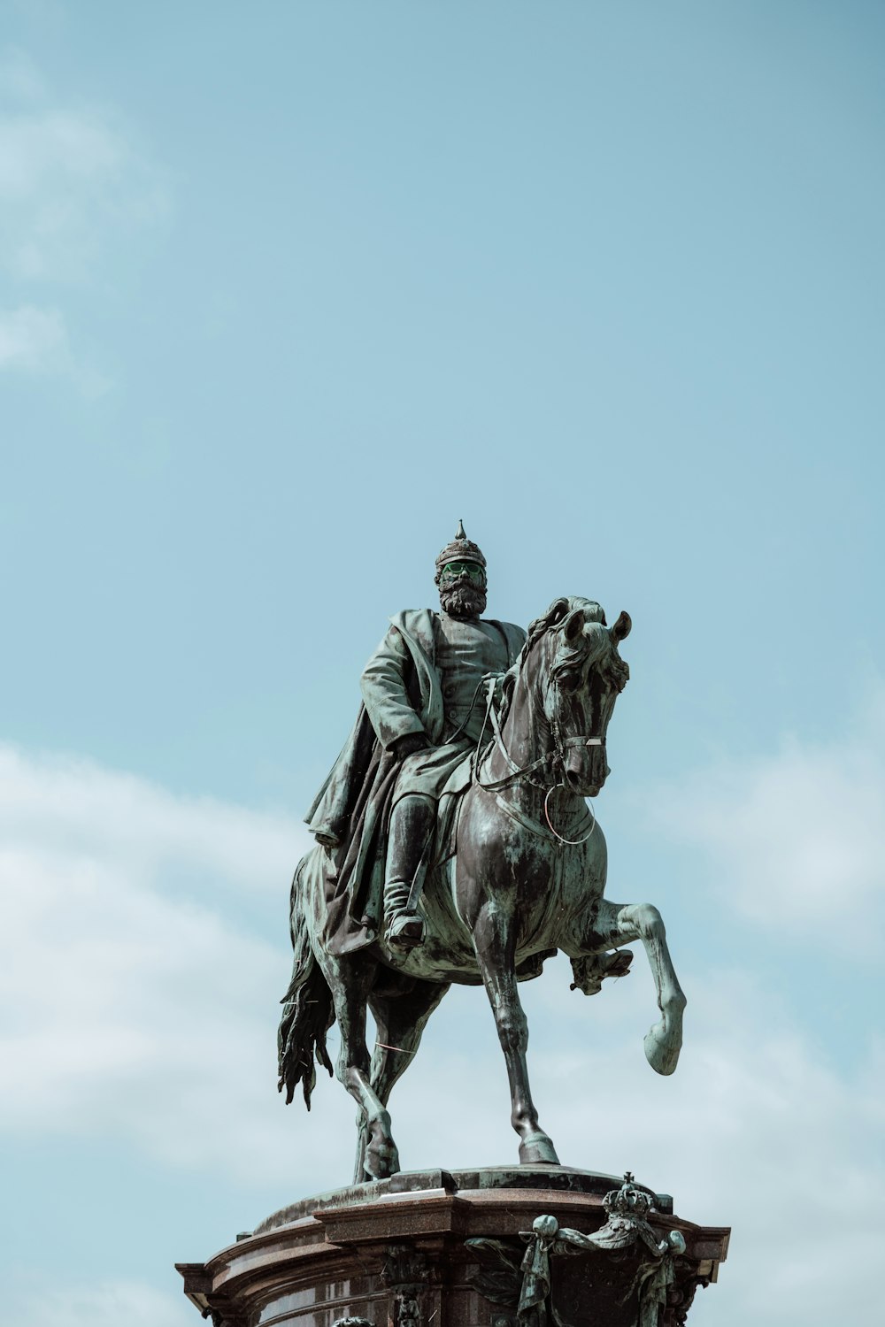 a statue of a man riding on the back of a horse