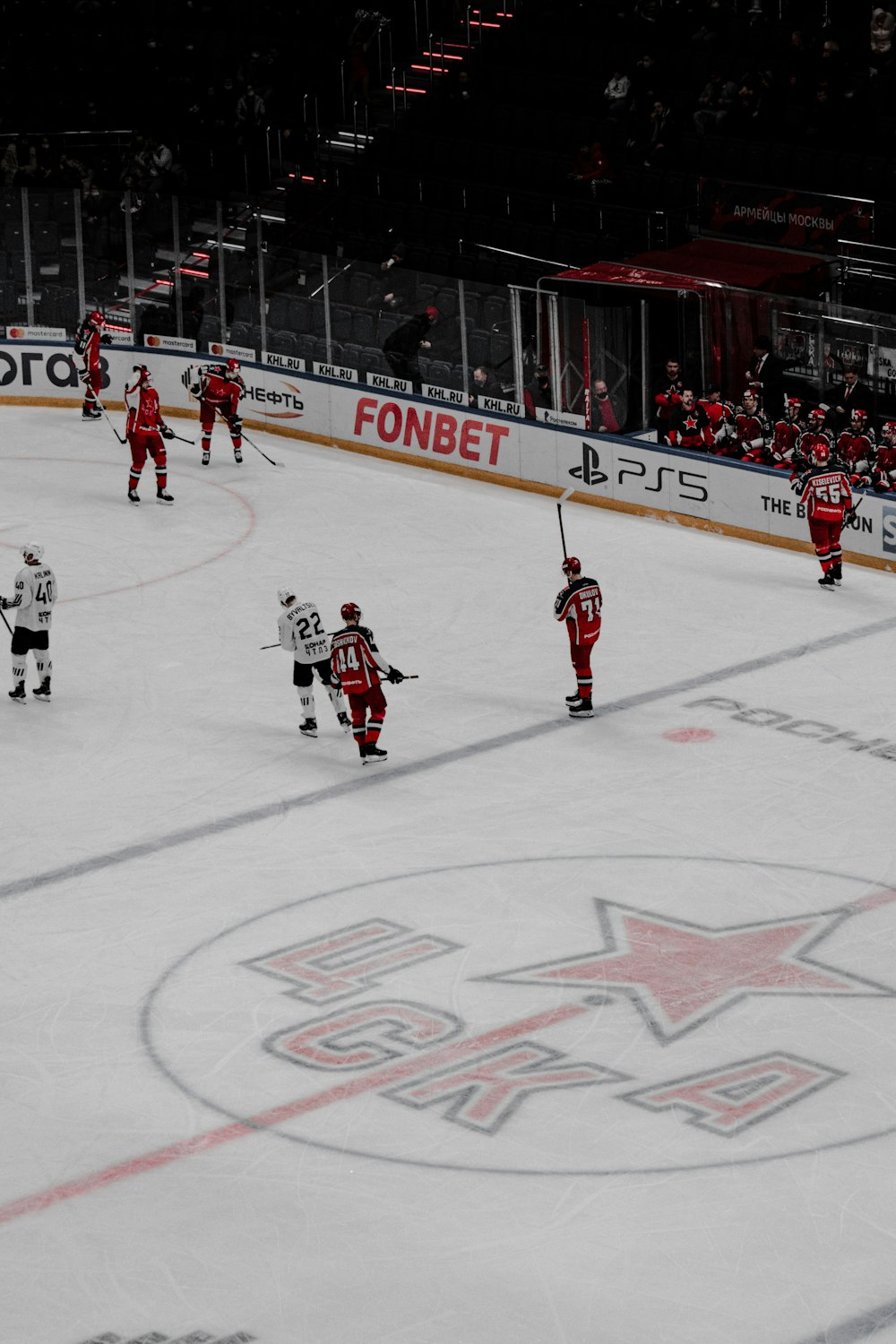 a group of people playing a game of ice hockey