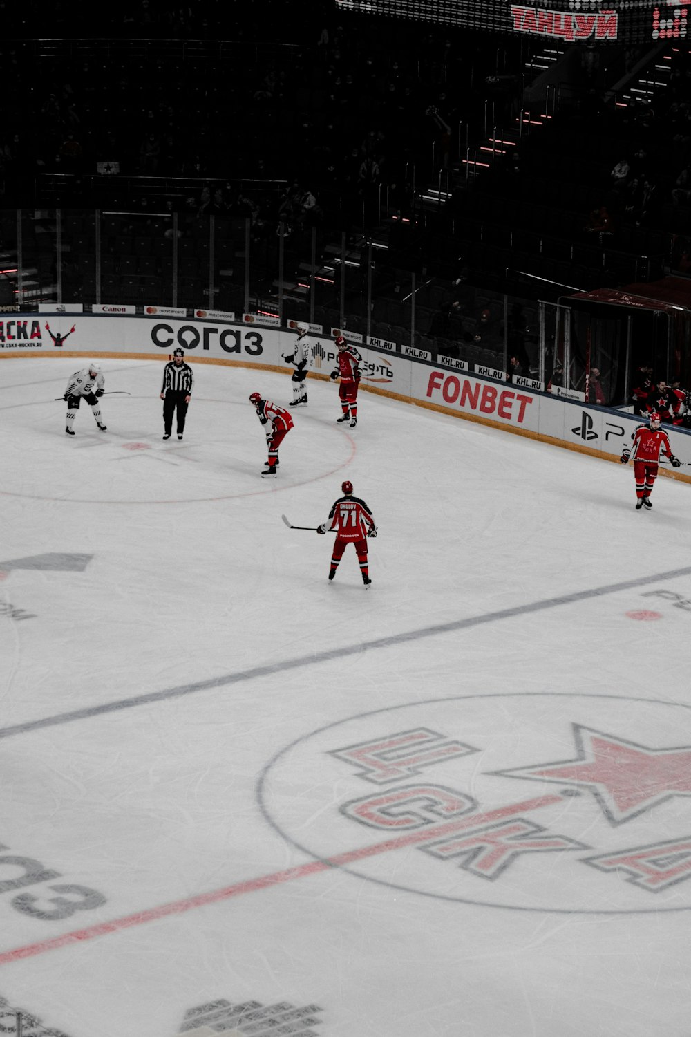 people playing ice hockey on ice field