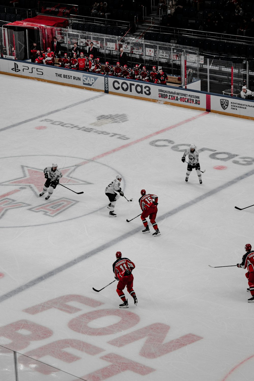 a group of people playing a game of ice hockey