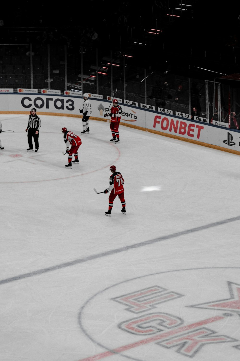 people playing ice hockey on ice field