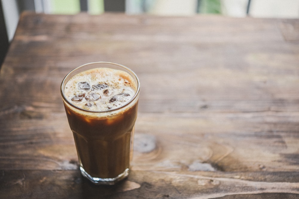 clear drinking glass with brown liquid