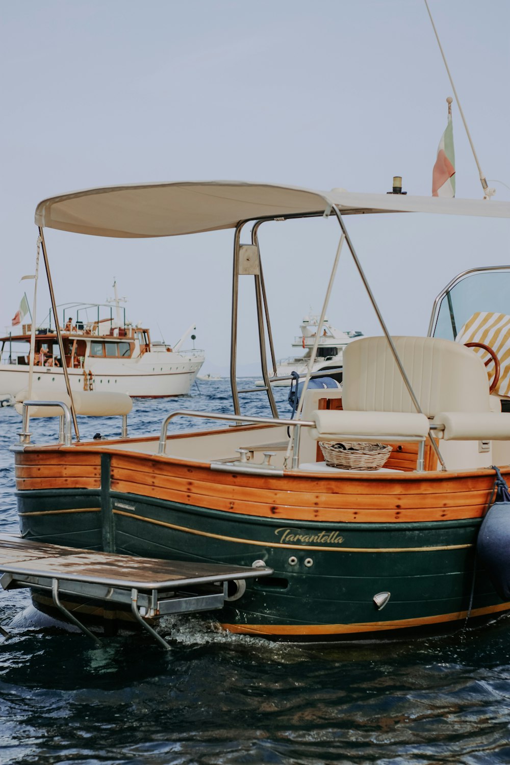 brown and white boat on sea during daytime