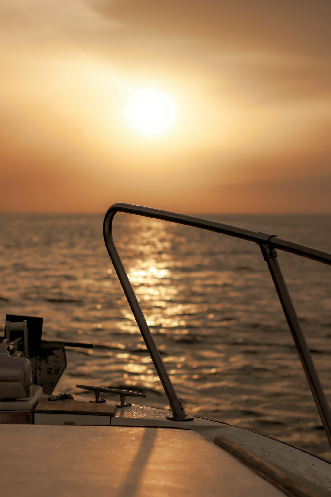 white and black ship on sea during sunset