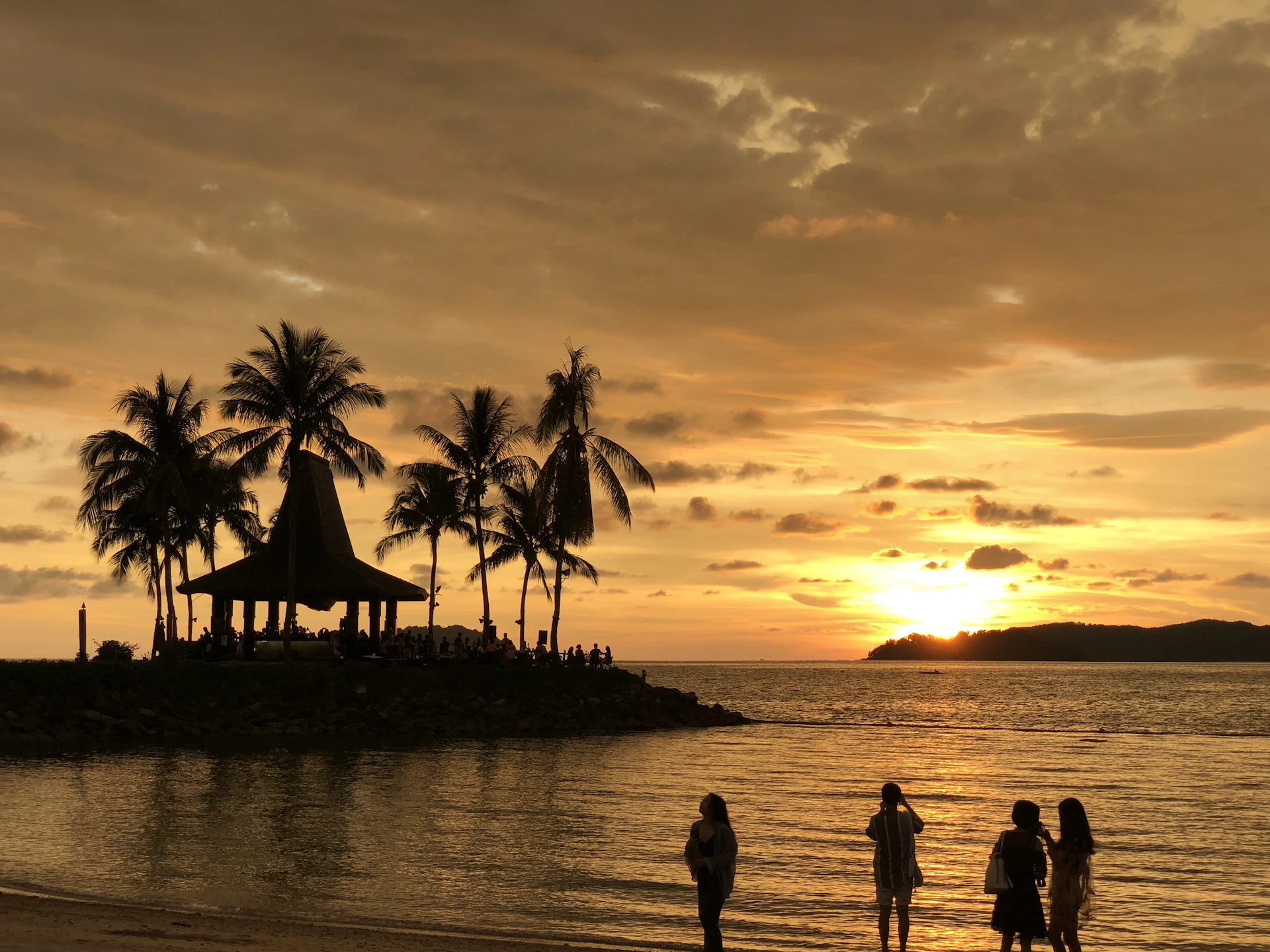 silhouette of people on beach during sunset