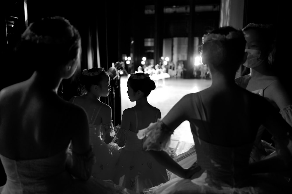 a black and white photo of a group of ballerinas