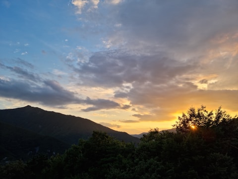 A beautifully framed photo of a sunset over a mountain range.