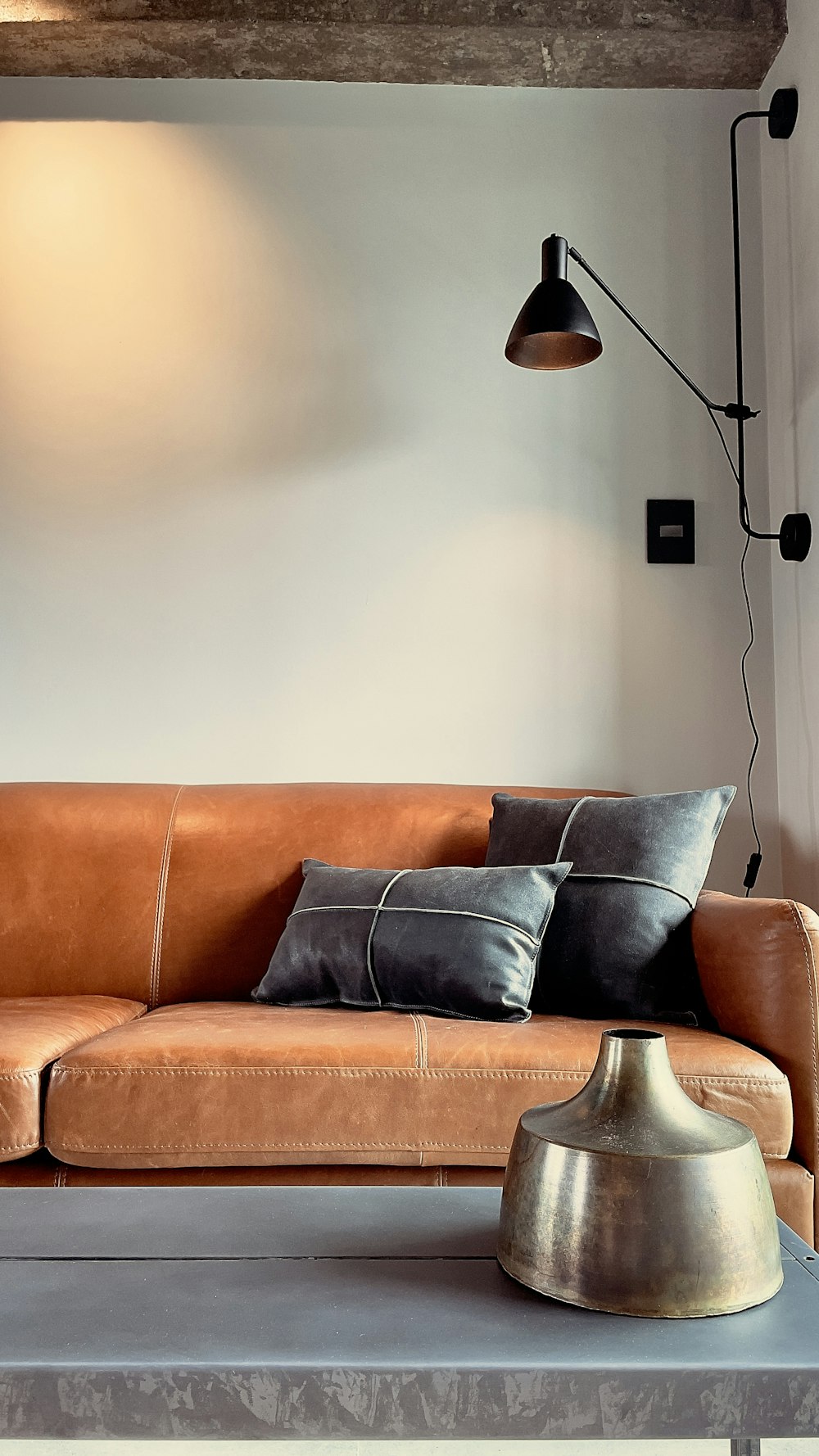 brown leather couch with throw pillows