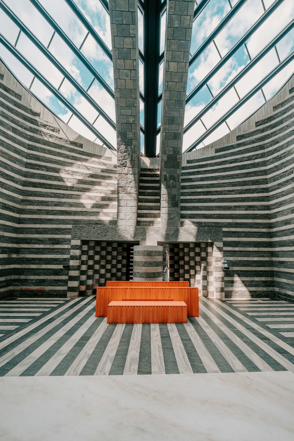 red wooden bench in a gray concrete building