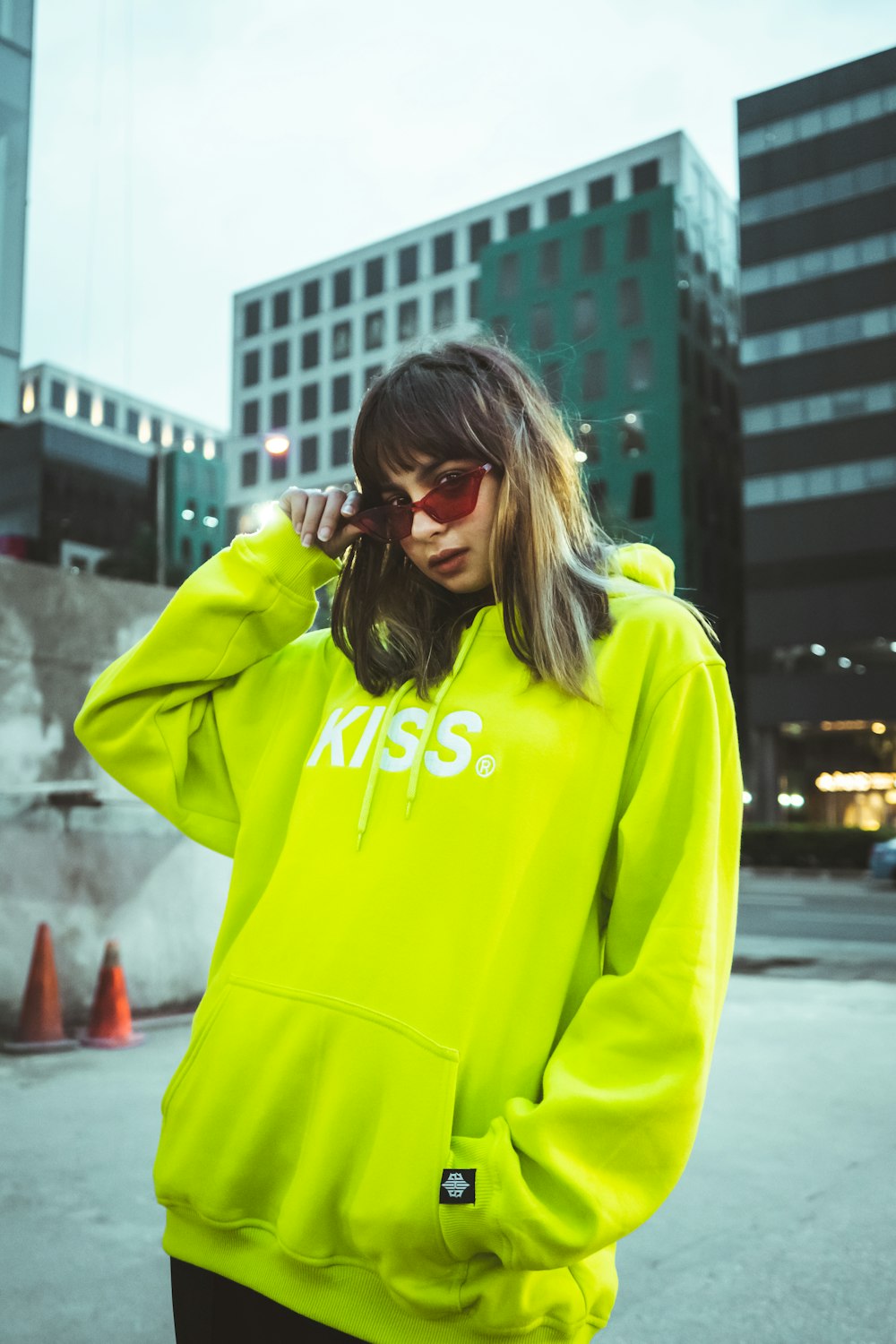 woman in yellow hoodie wearing black sunglasses