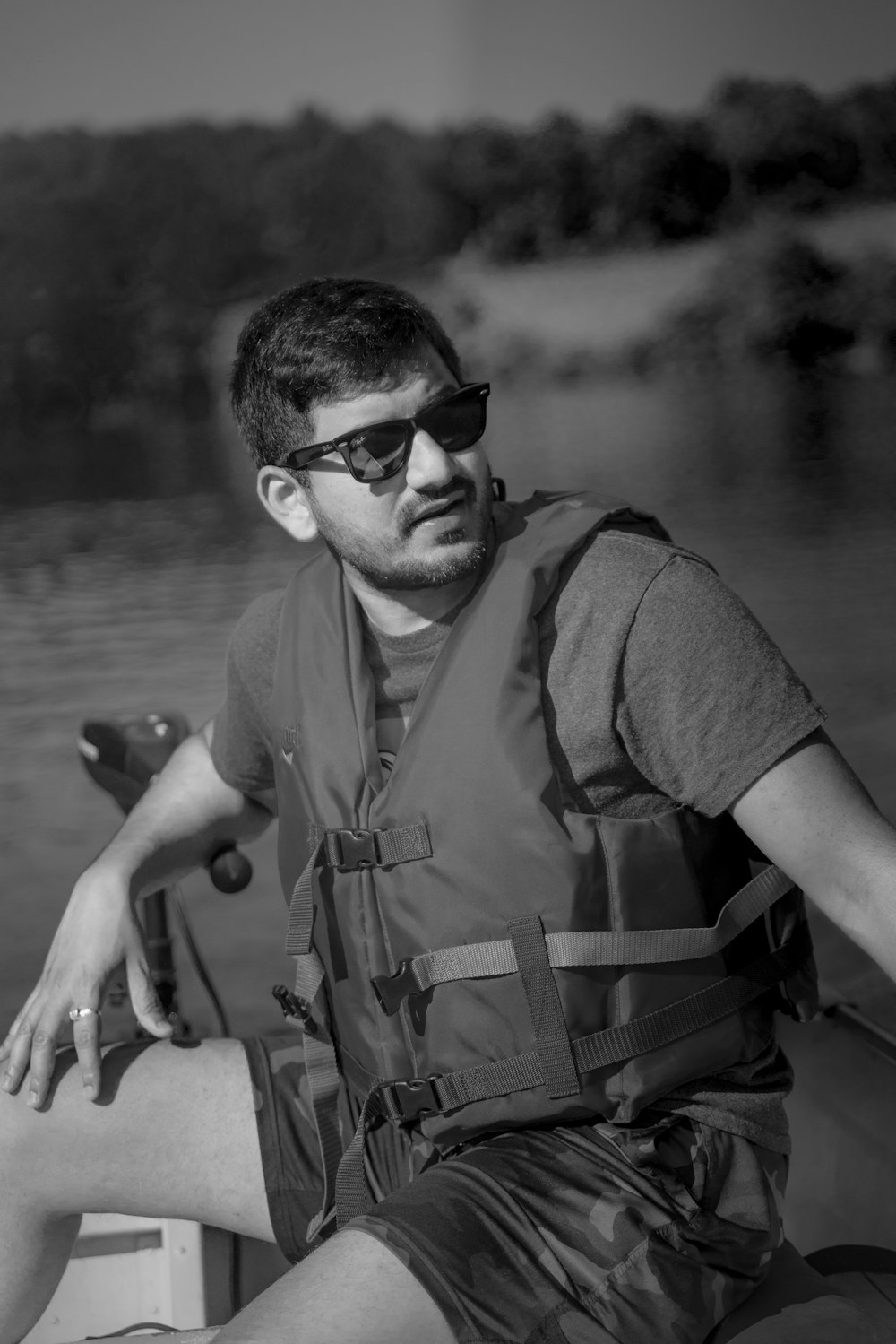 man in brown vest and black sunglasses holding fishing rod