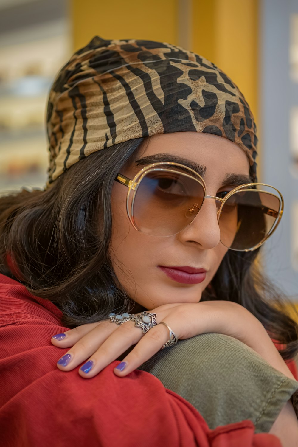 woman in red shirt wearing brown and black sunglasses