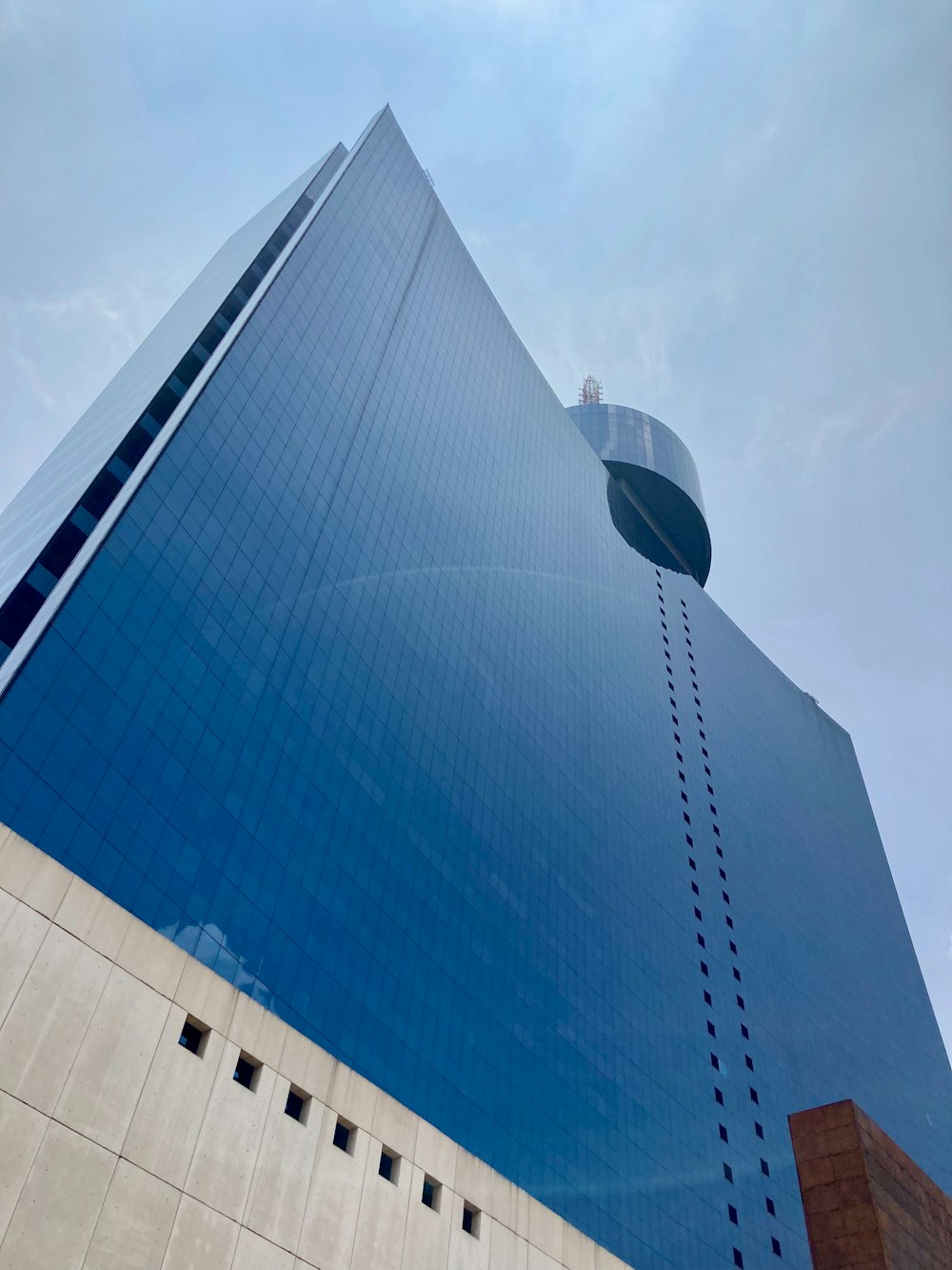 white and blue glass walled high rise building