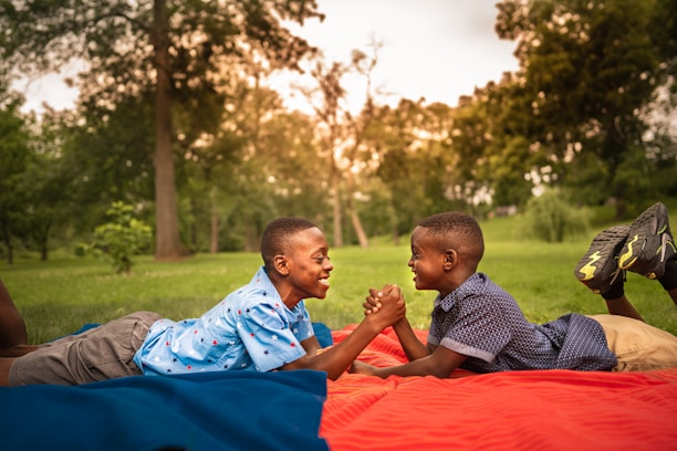 man in blue and white checkered dress shirt sitting on red textile