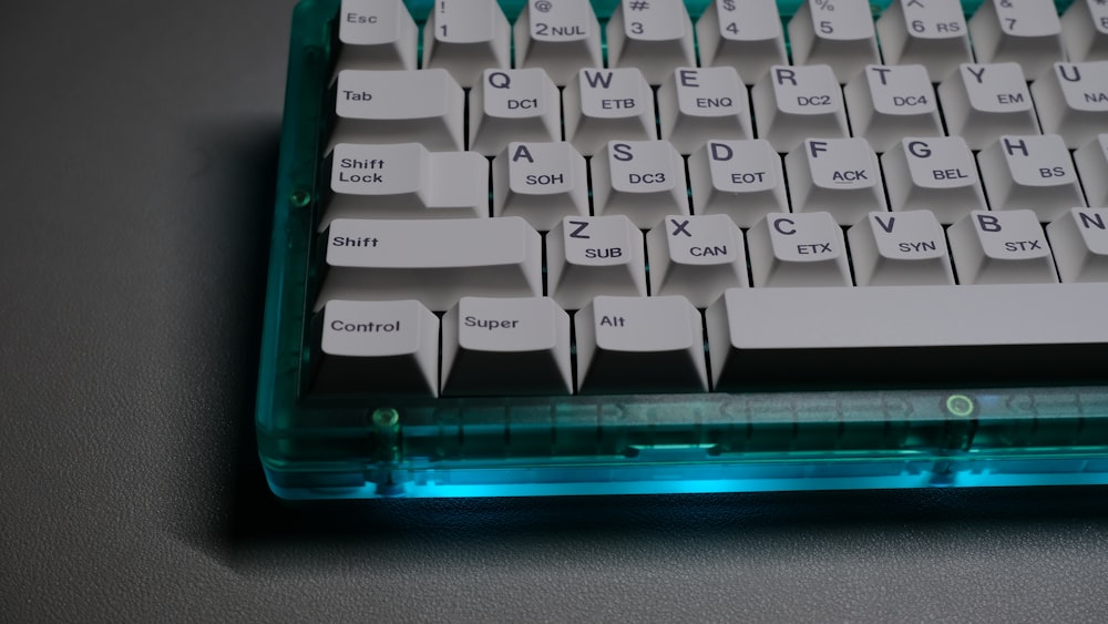 white computer keyboard on black table