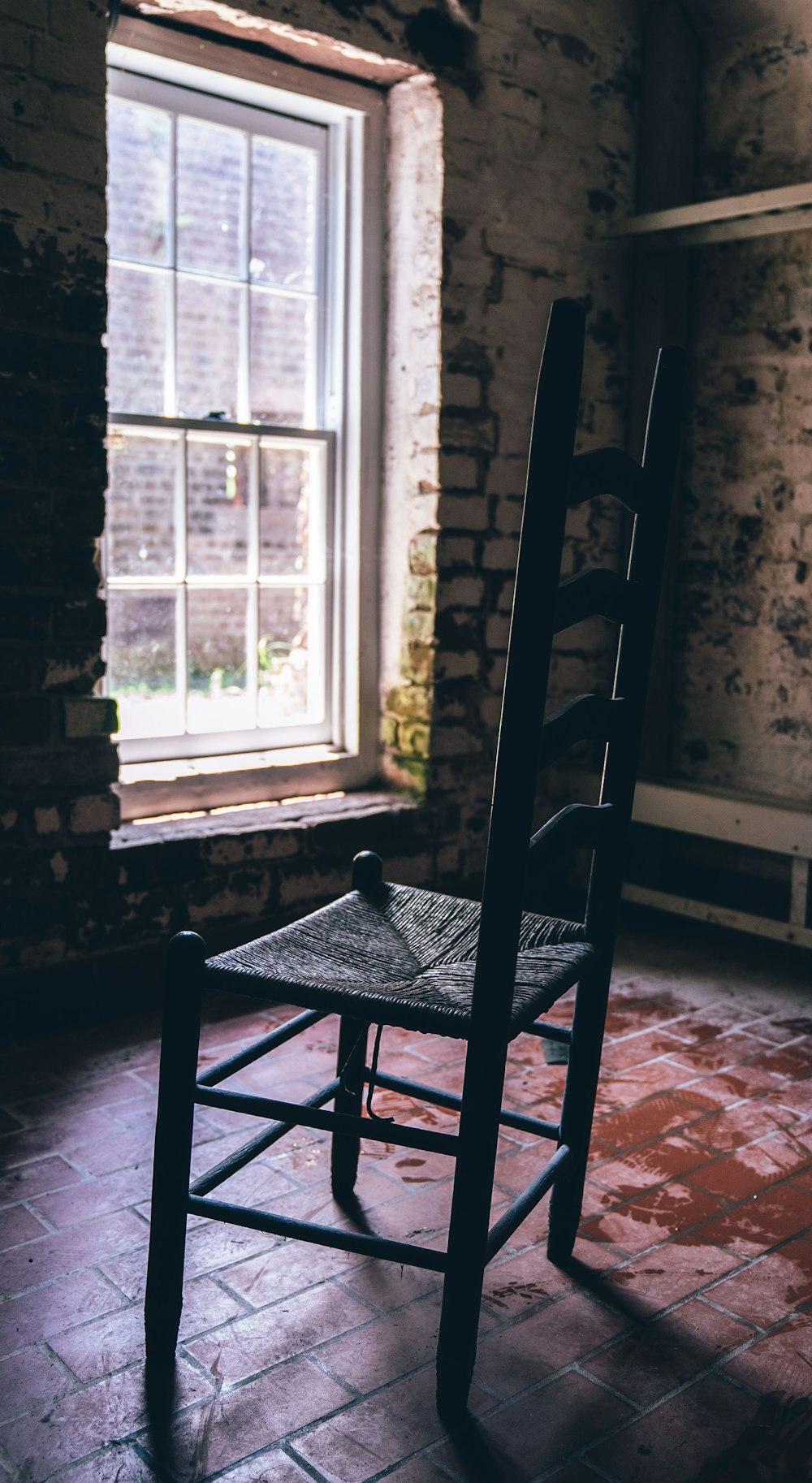 black wooden chair near window
