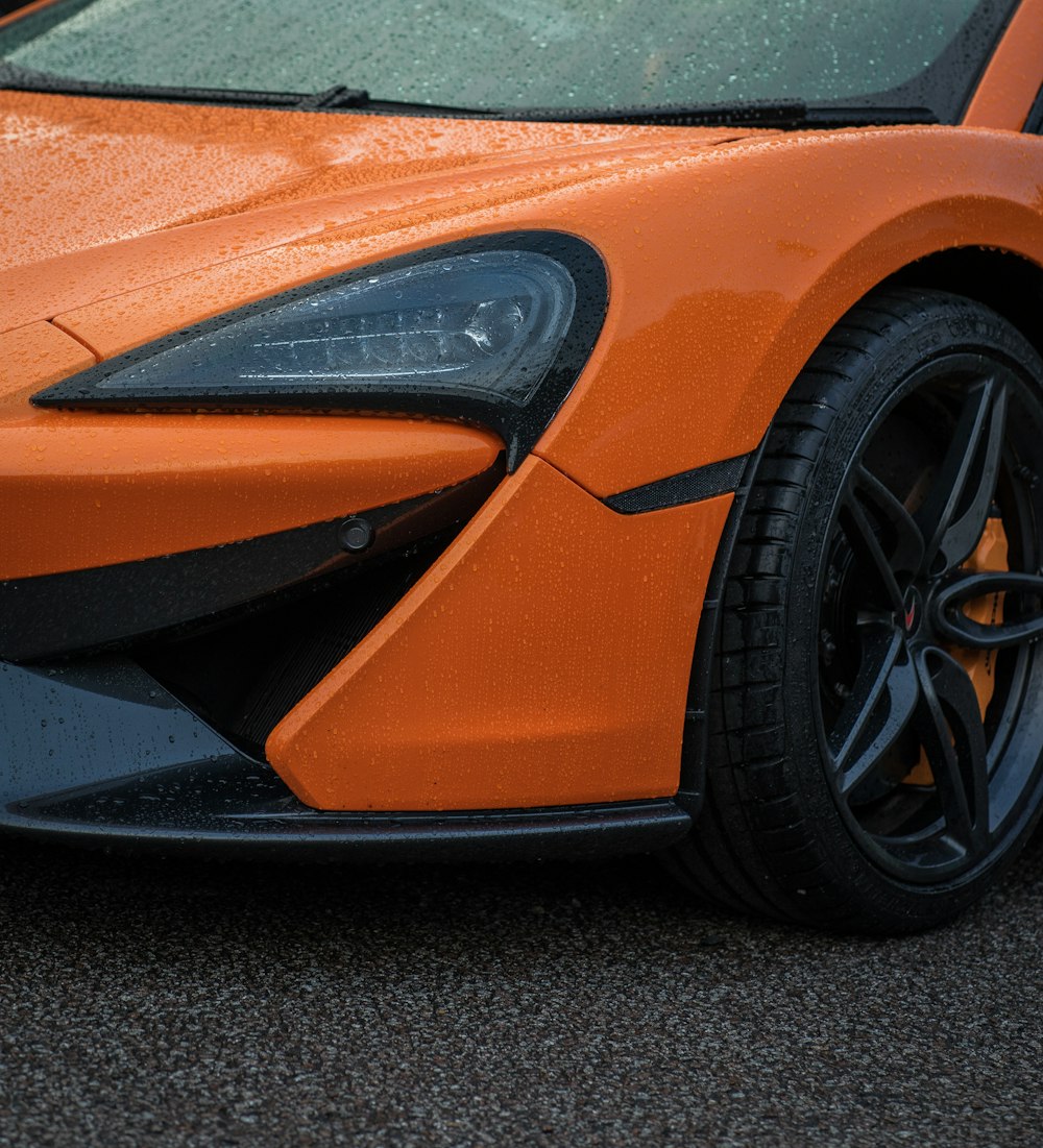 orange ferrari car on black asphalt road