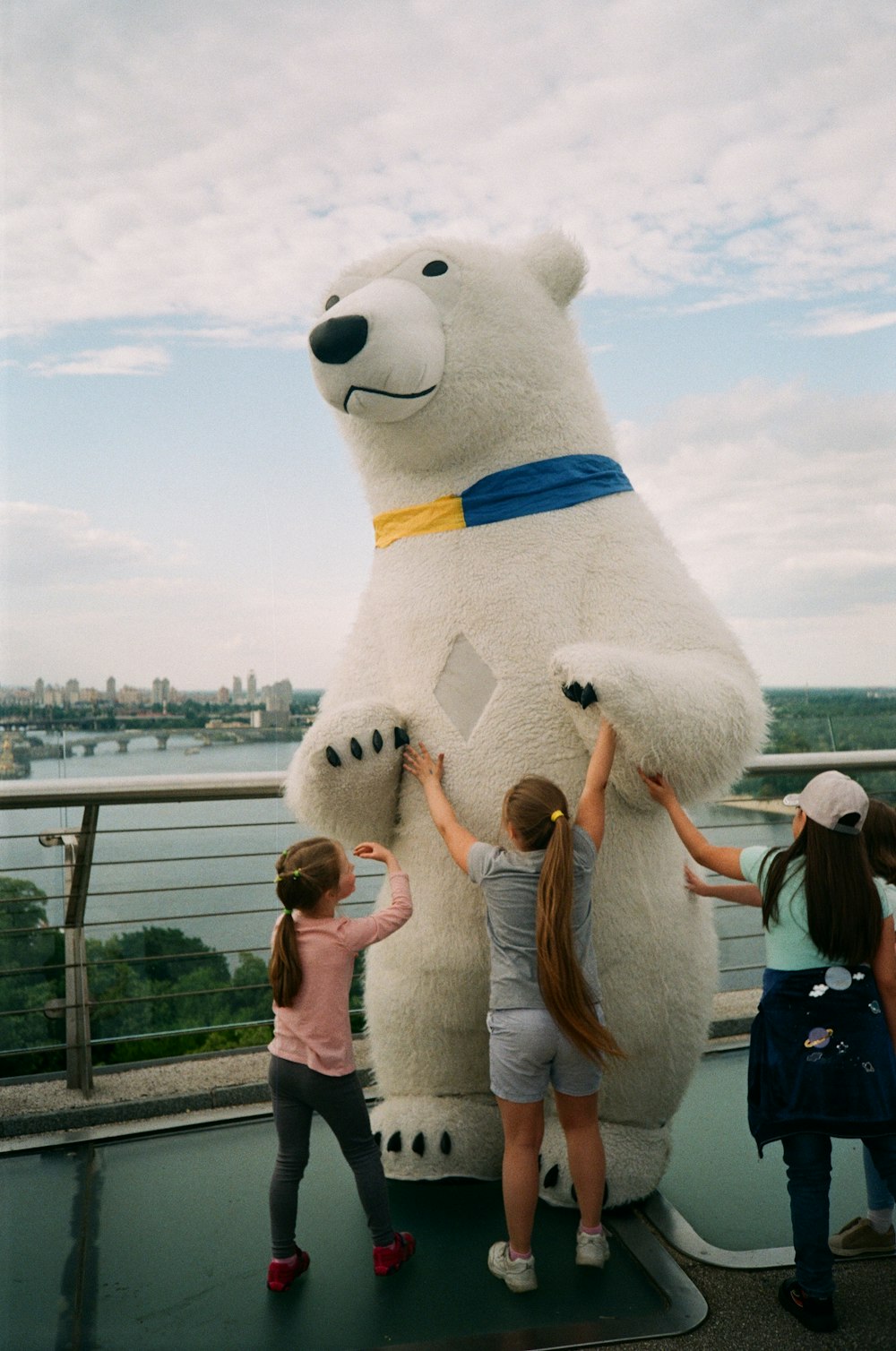 people standing beside white polar bear statue during daytime