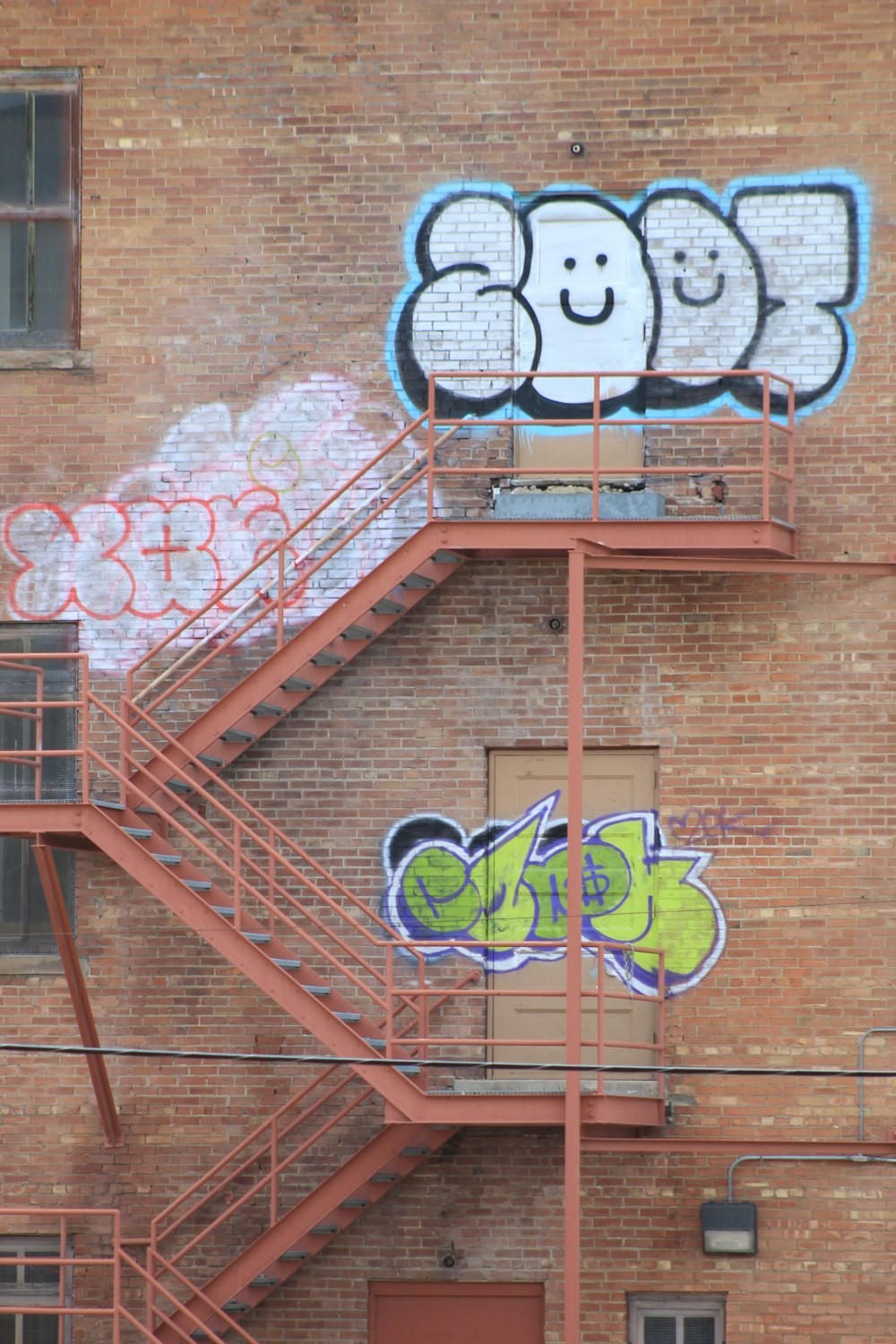 red metal railings with graffiti