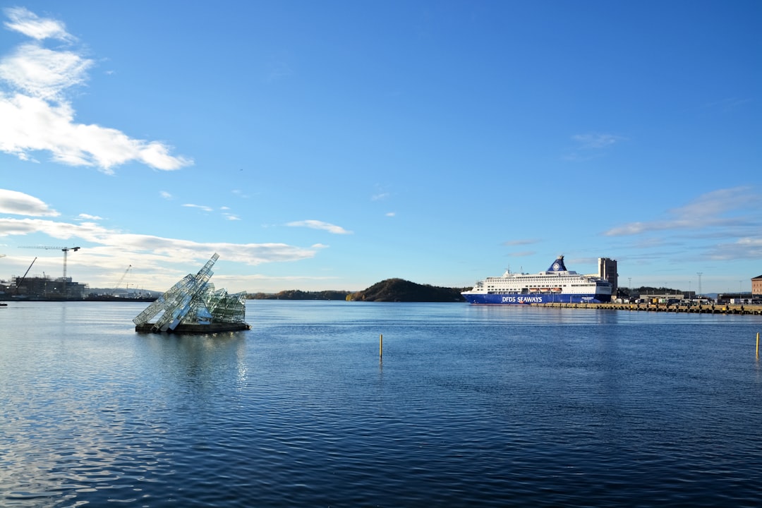 black ship on sea under blue sky during daytime