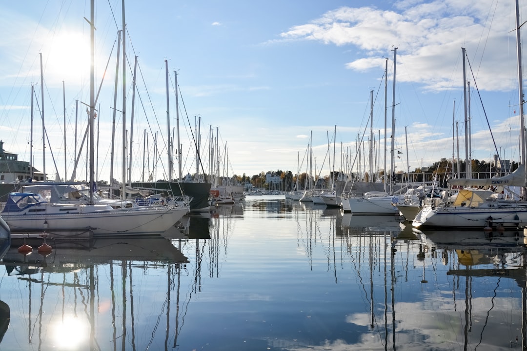 white and blue boats on sea under blue sky during daytime