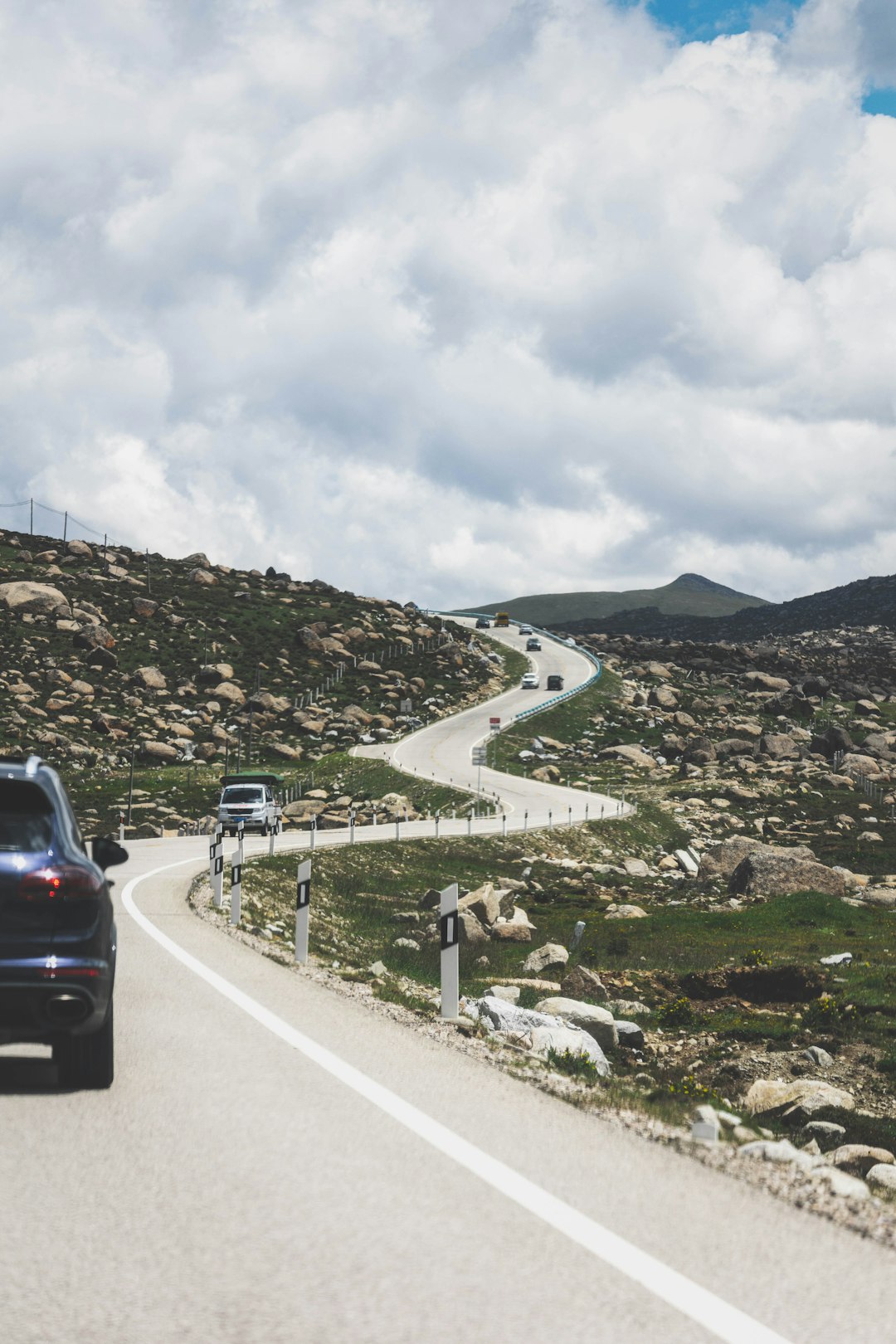 black suv on road near mountain during daytime