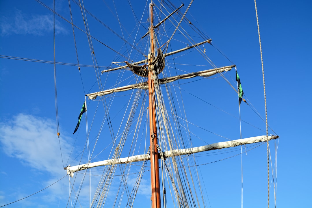 brown and black ship under blue sky during daytime