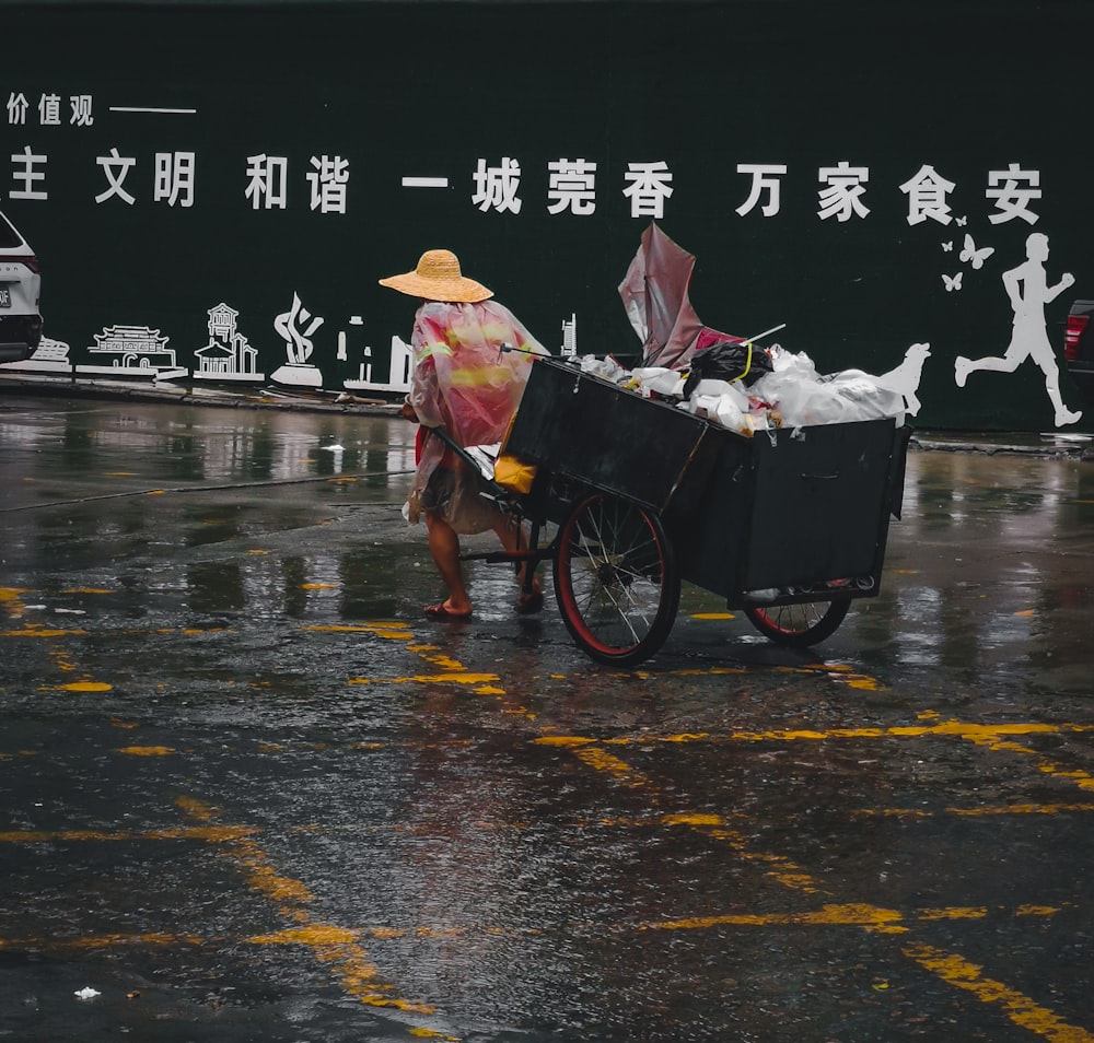 man in brown jacket riding on black bicycle on wet road during daytime